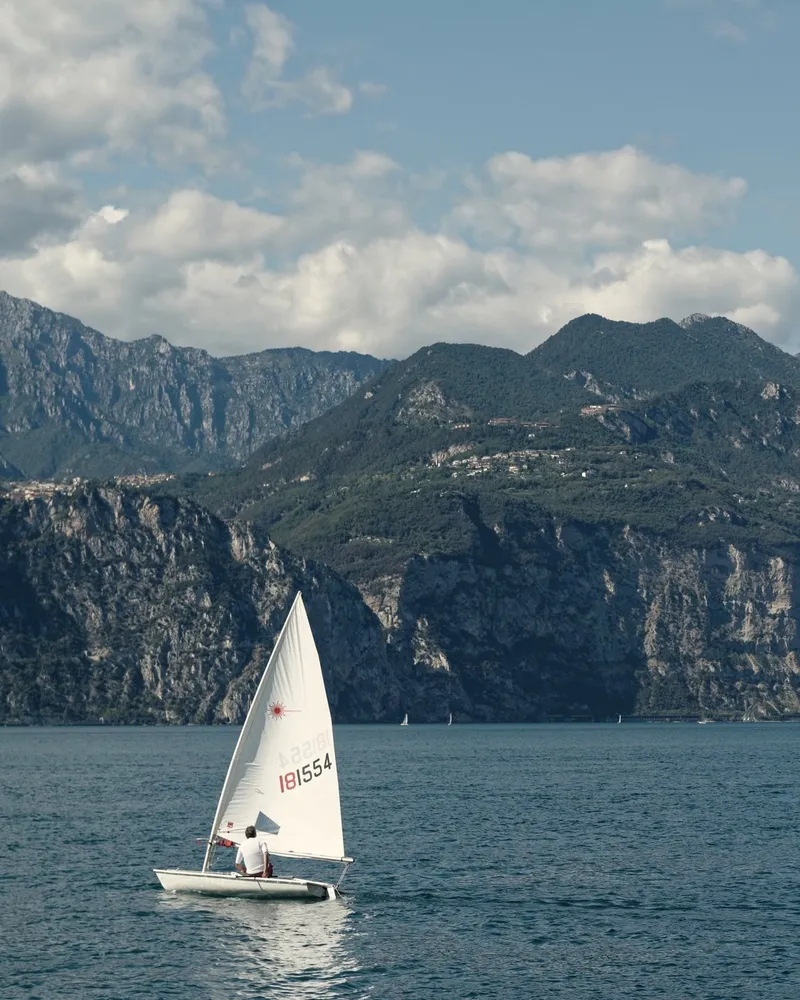 A dinghy sailing off Nago–Torbole